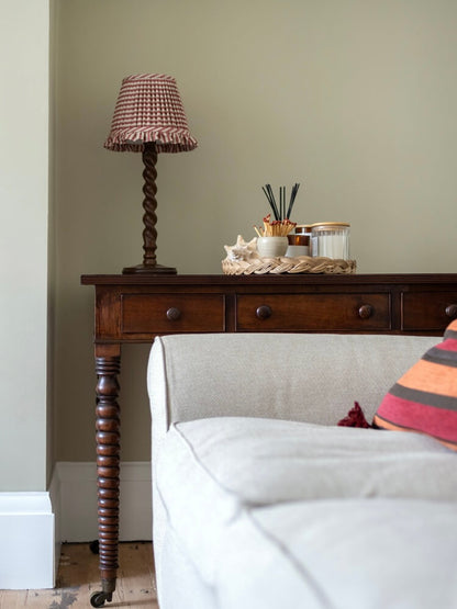 Antique bobbin console table on brass casters