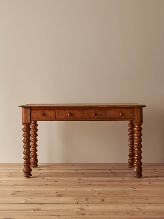 Victorian oak bobbin desk on castors