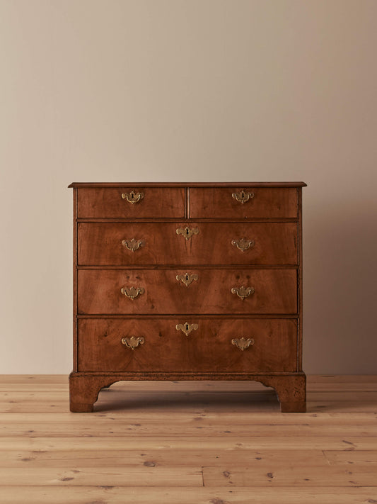 Georgian walnut chest of drawers raised on bracket feet