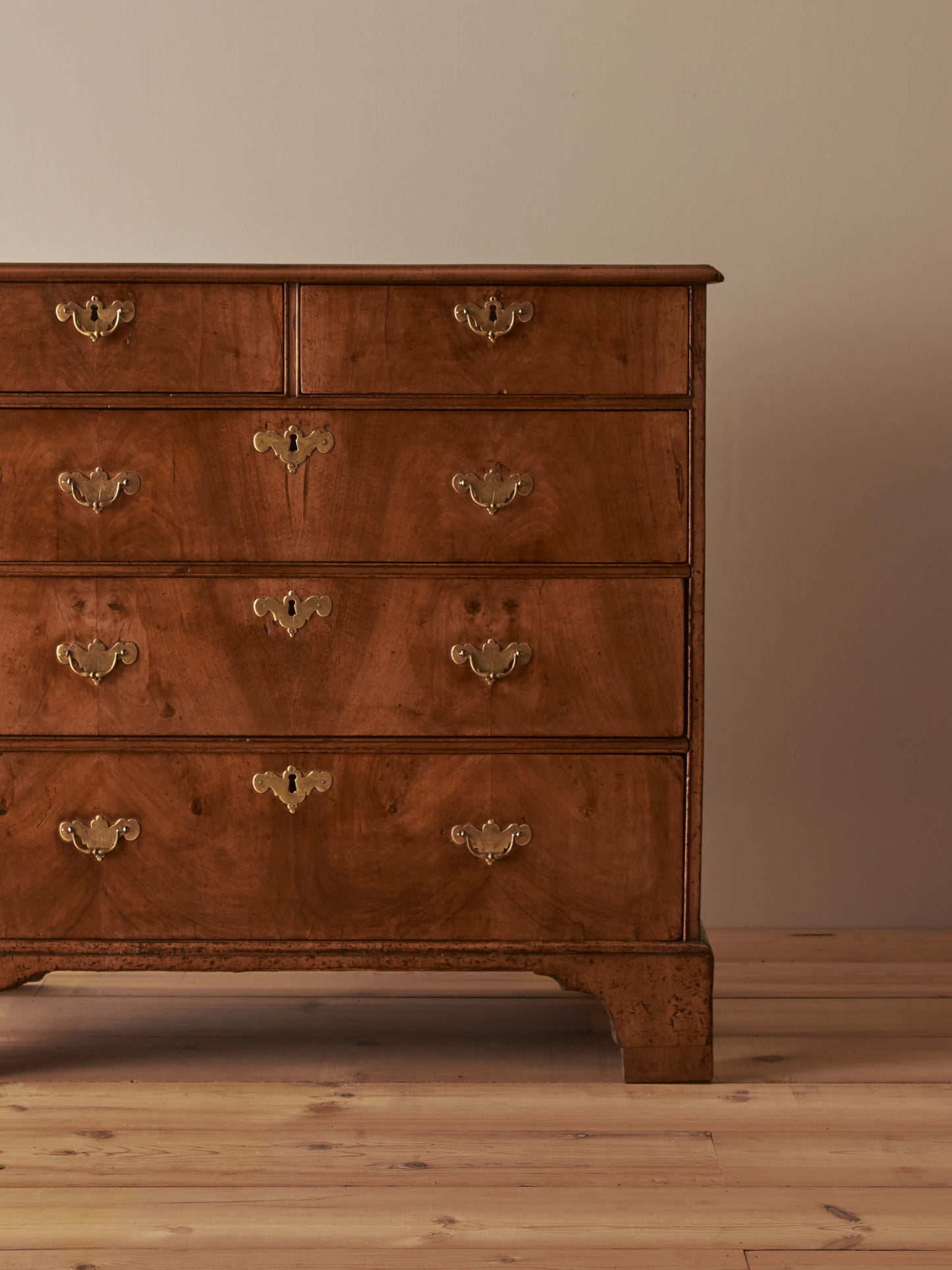 Georgian walnut chest of drawers raised on bracket feet