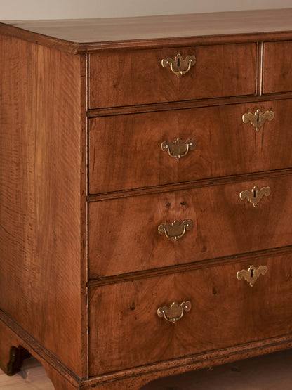 Georgian walnut chest of drawers raised on bracket feet