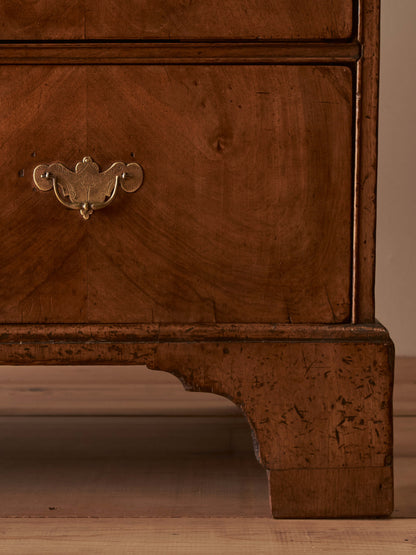 Georgian walnut chest of drawers raised on bracket feet
