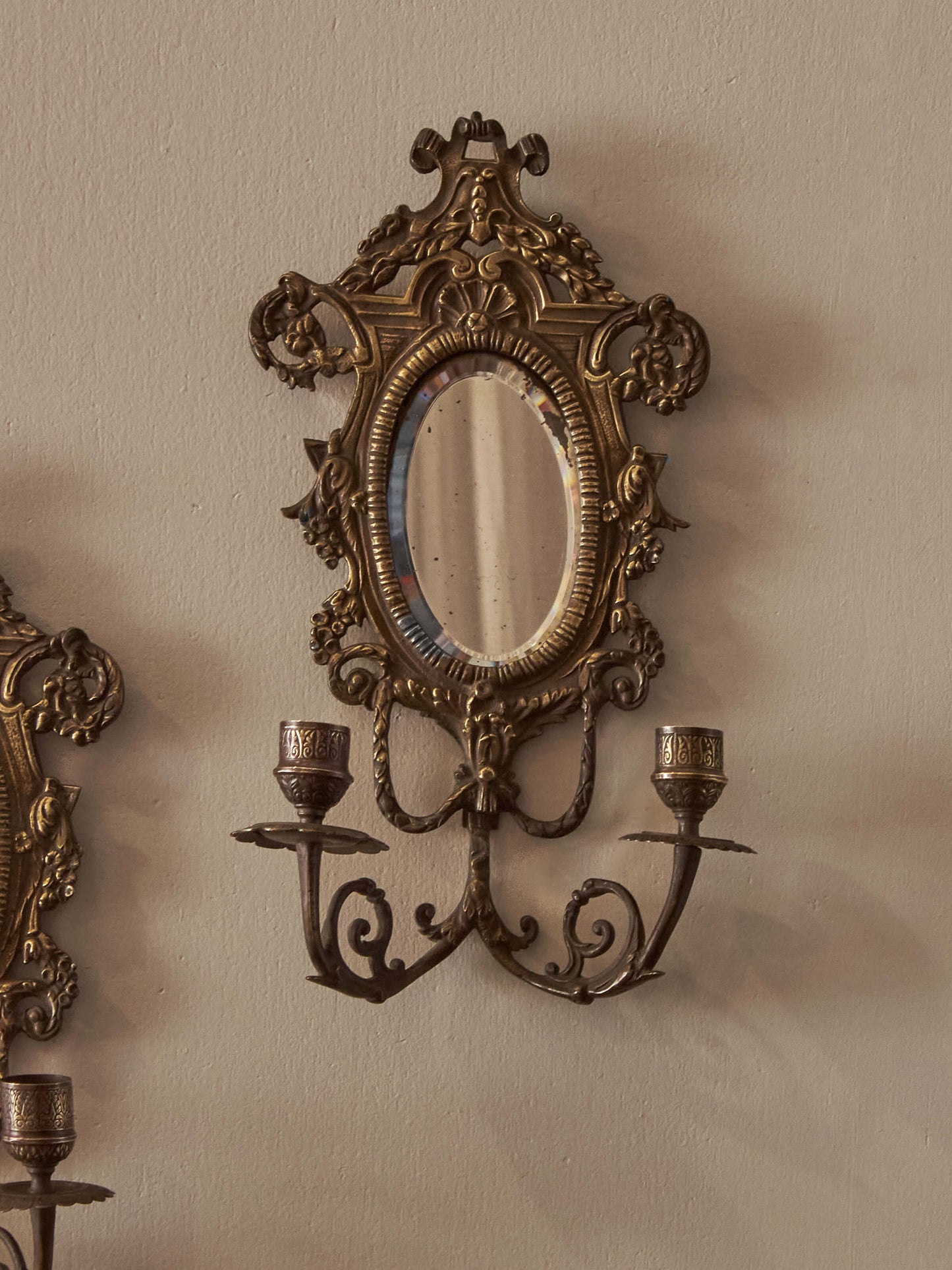 Pair of French antique mirrored brass candle sconces