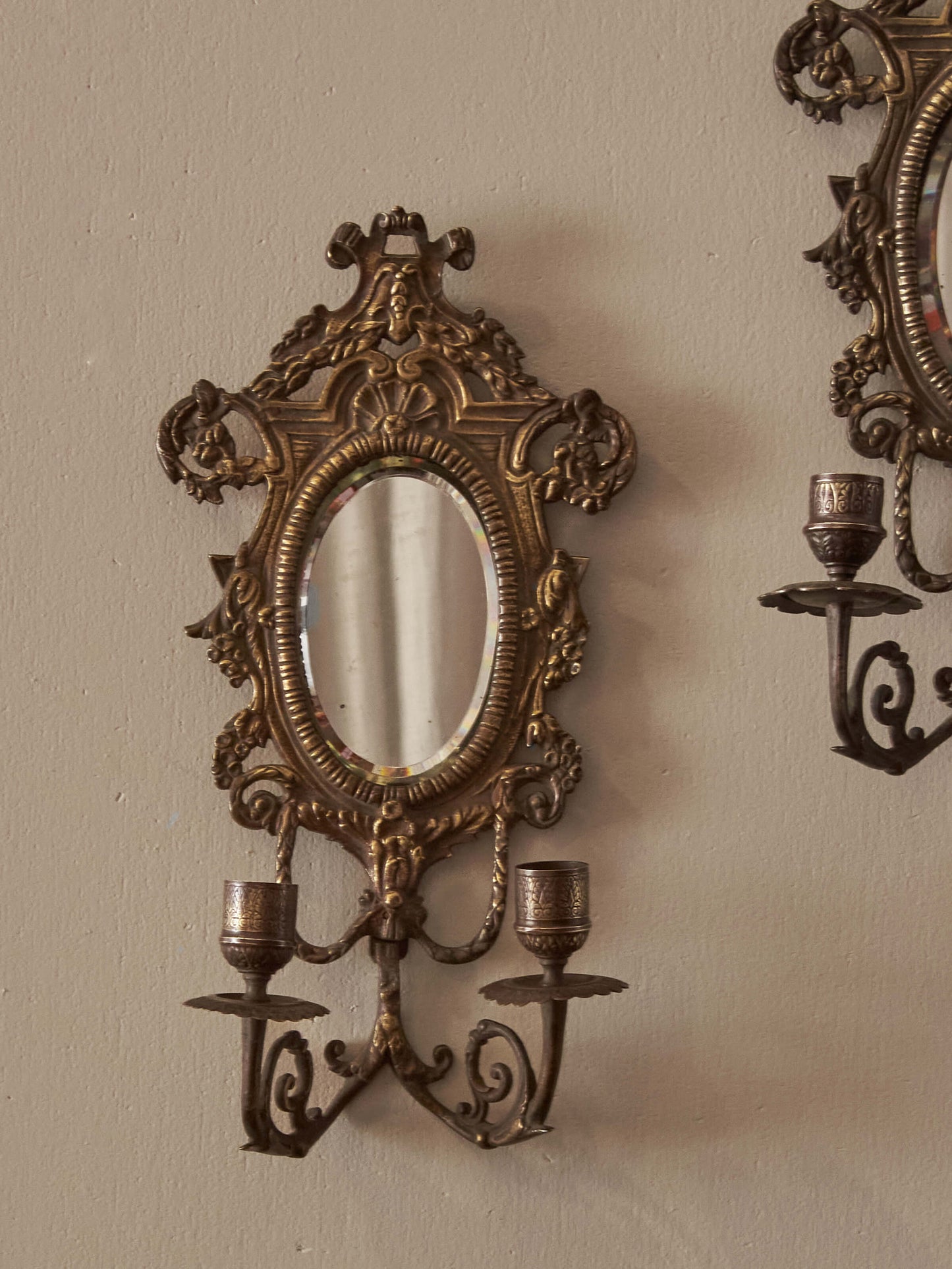 Pair of French antique mirrored brass candle sconces