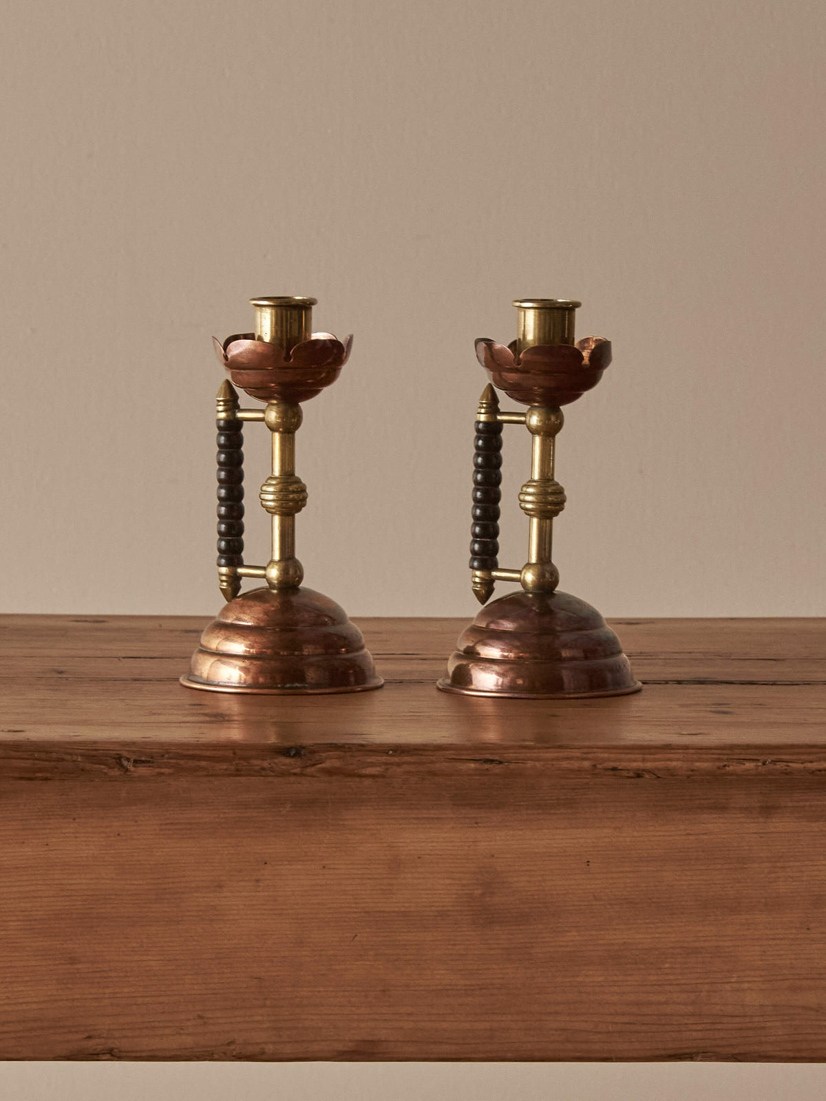 A pair of Arts and Crafts candlesticks by Christopher Dresser