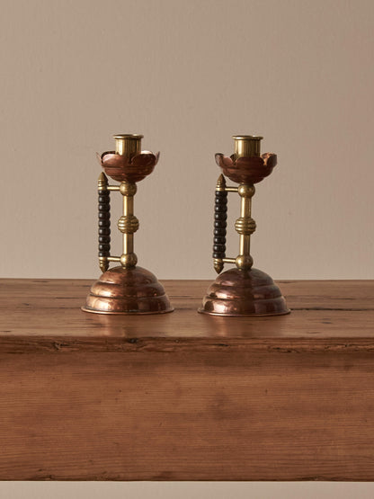 A pair of Arts and Crafts candlesticks by Christopher Dresser