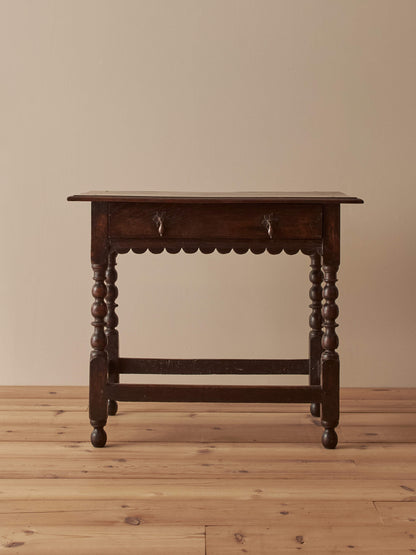 Early 18th century side table with scalloped apron