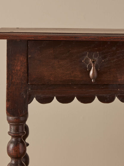 Early 18th century side table with scalloped apron