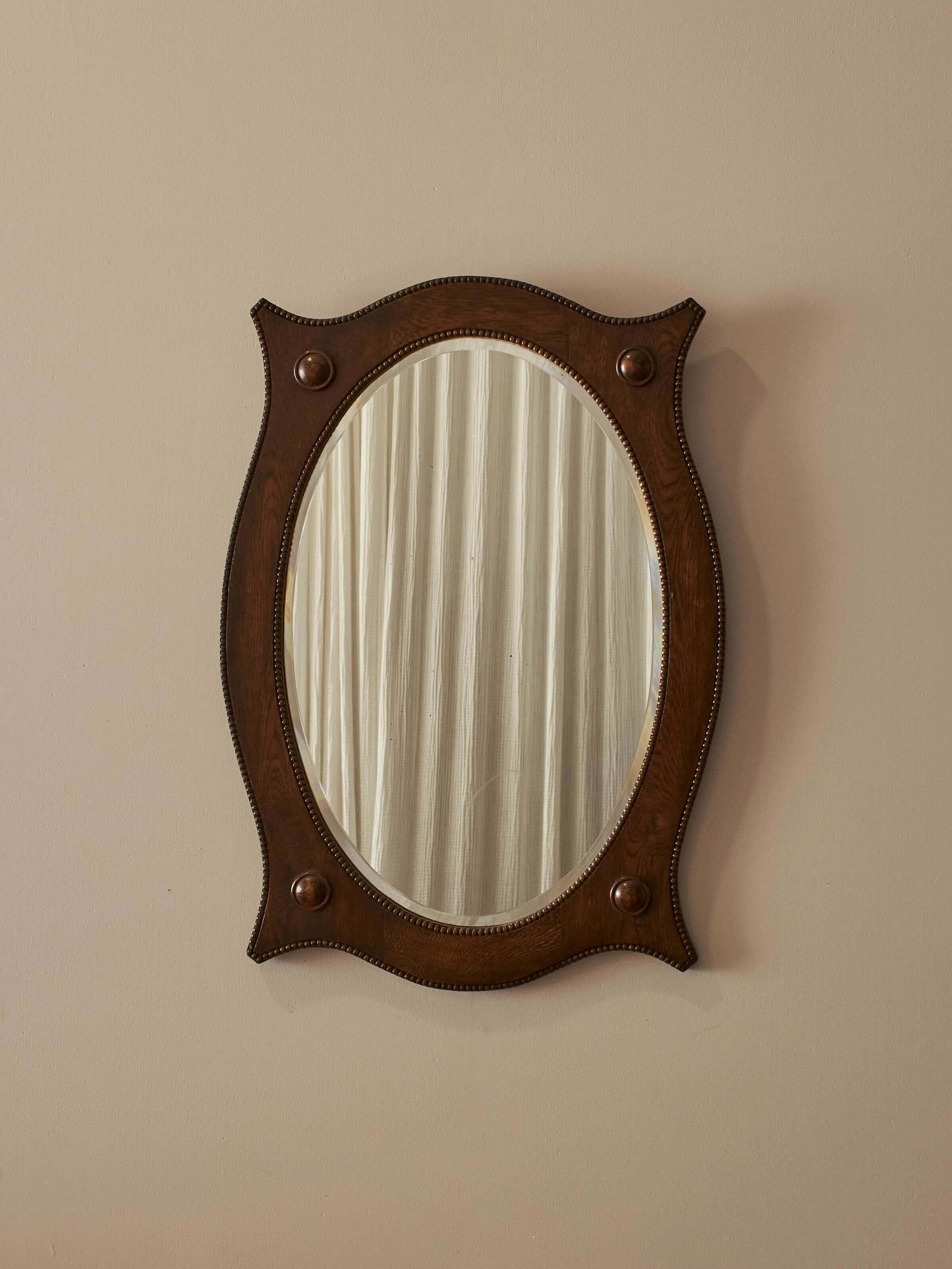 Edwardian oval oak mirror with bobbin detailing