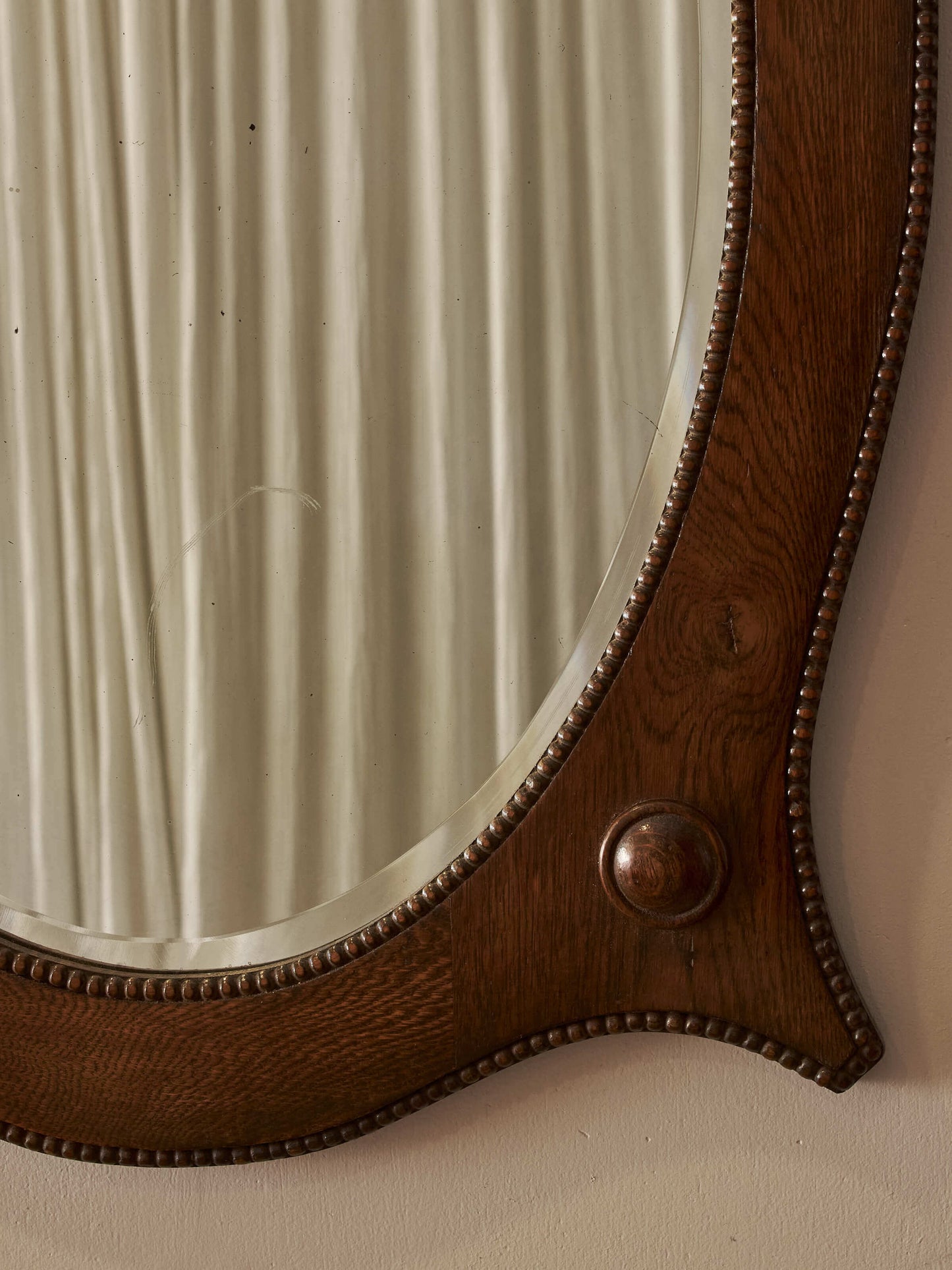 Edwardian oval oak mirror with bobbin detailing