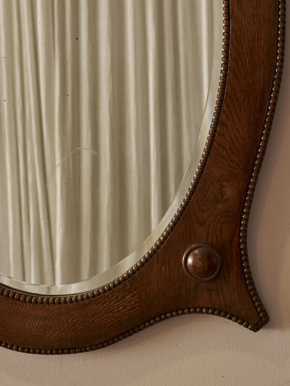 Edwardian oval oak mirror with bobbin detailing