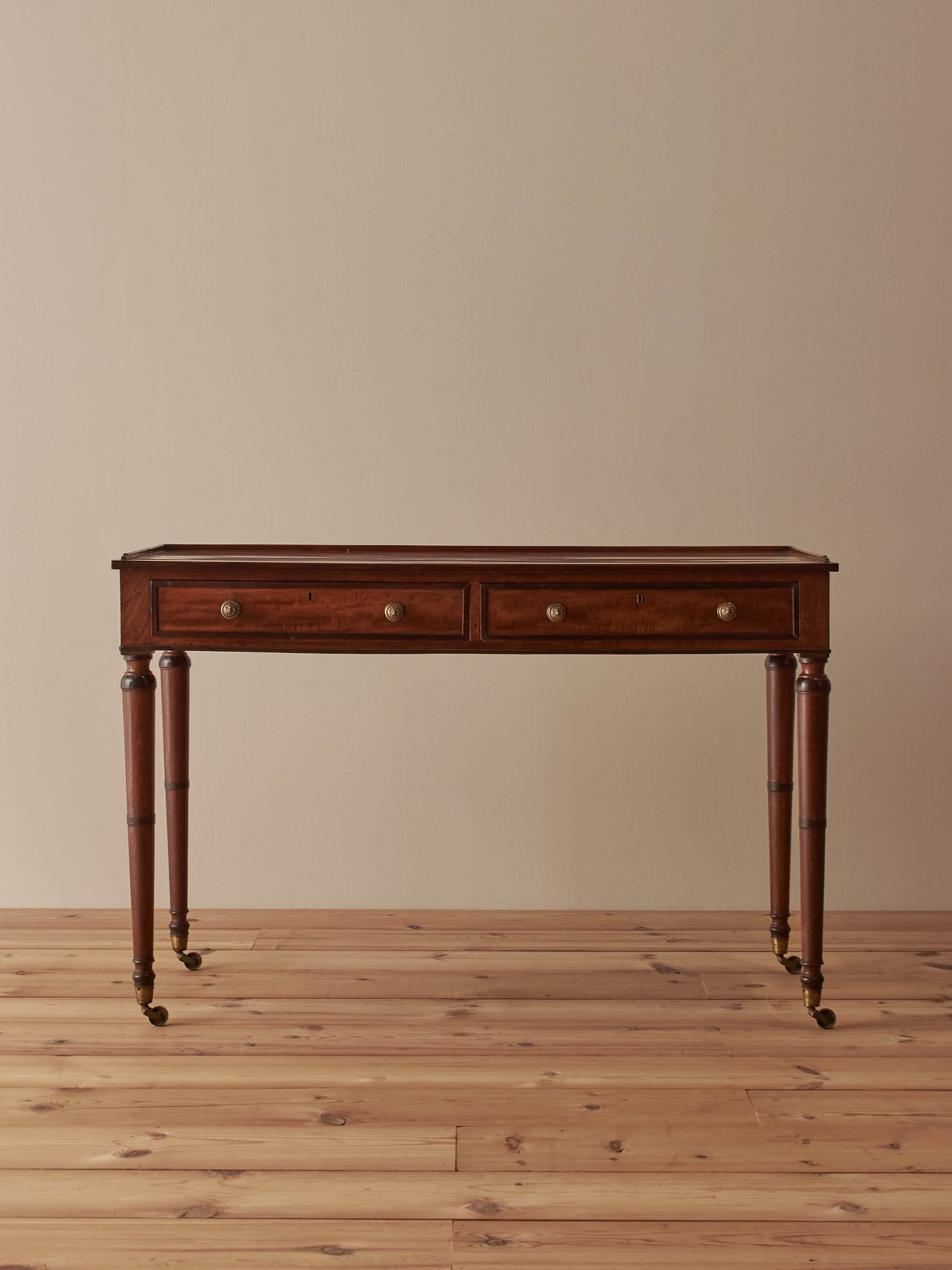 Regency mahogany desk on brass castors