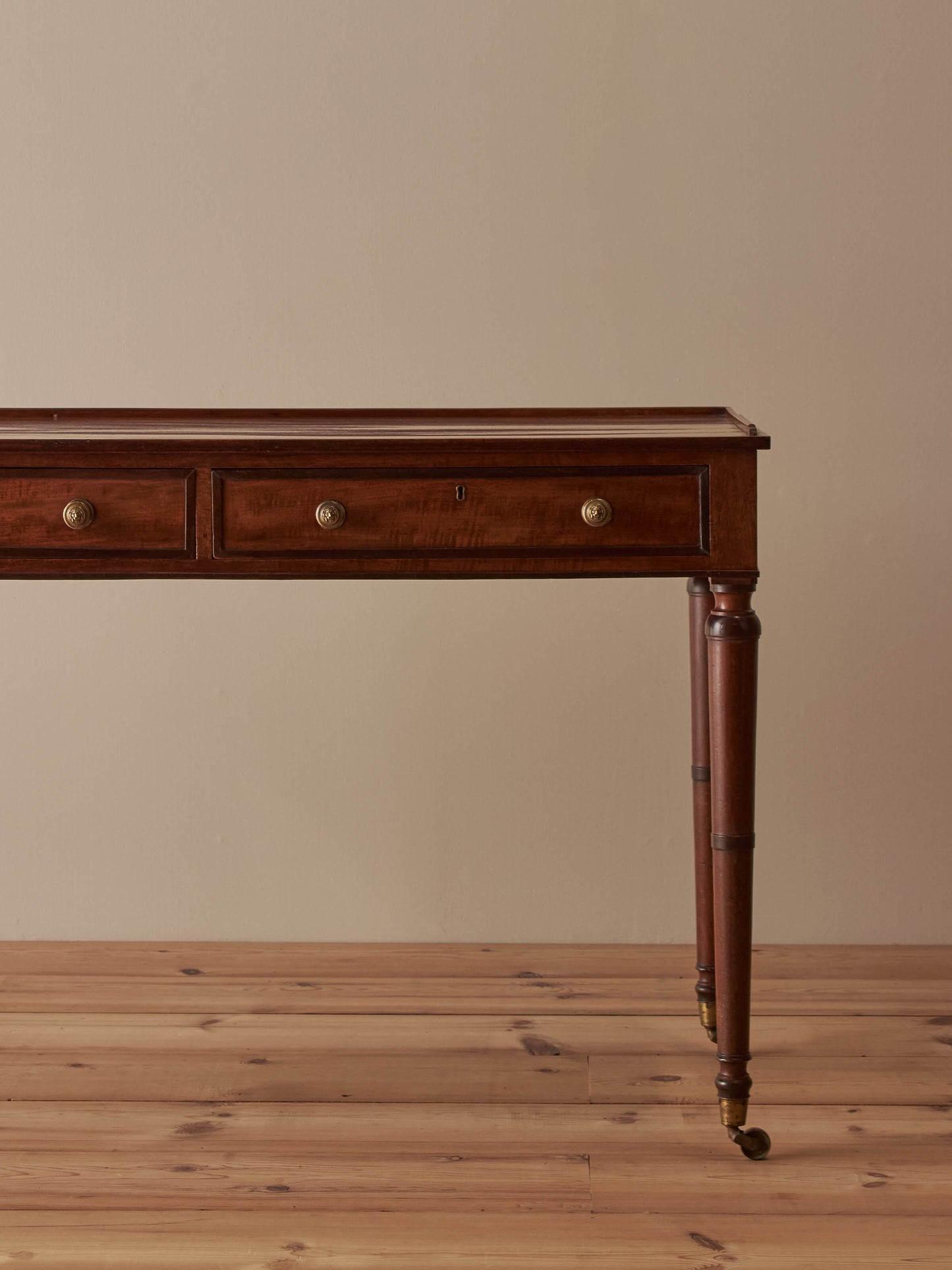 Regency mahogany desk on brass castors