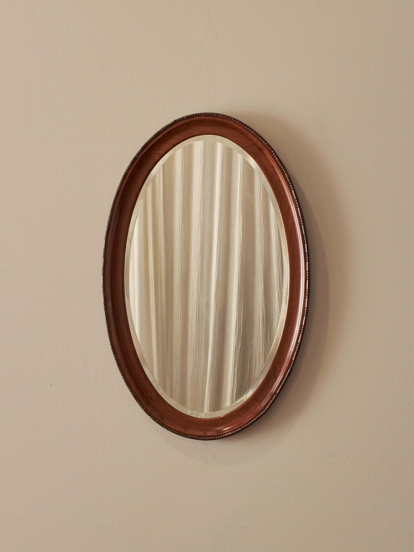 Antique oval walnut mirror with bobbin detailing