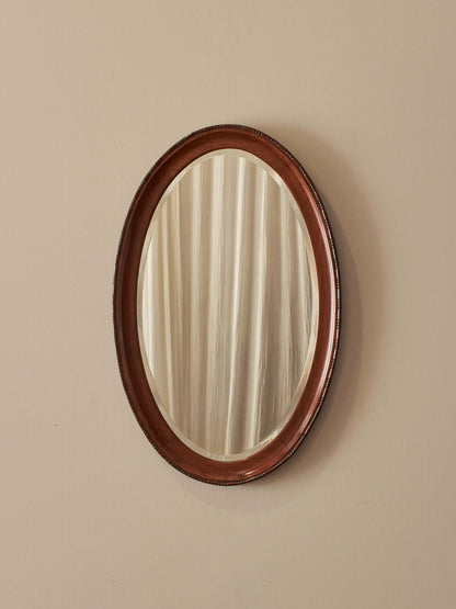 Antique oval walnut mirror with bobbin detailing