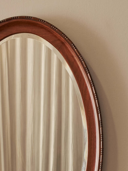 Antique oval walnut mirror with bobbin detailing
