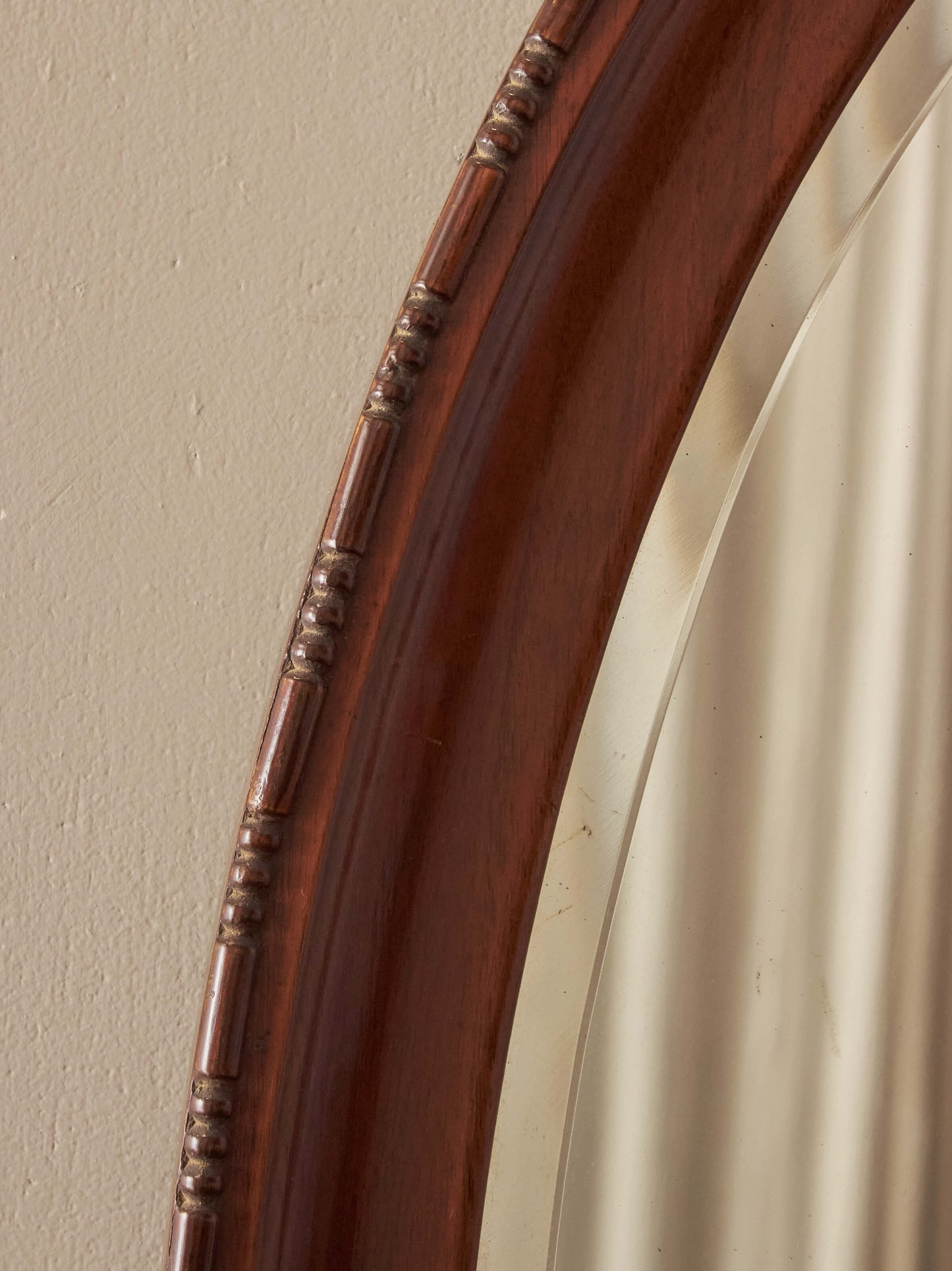 Antique oval walnut mirror with bobbin detailing