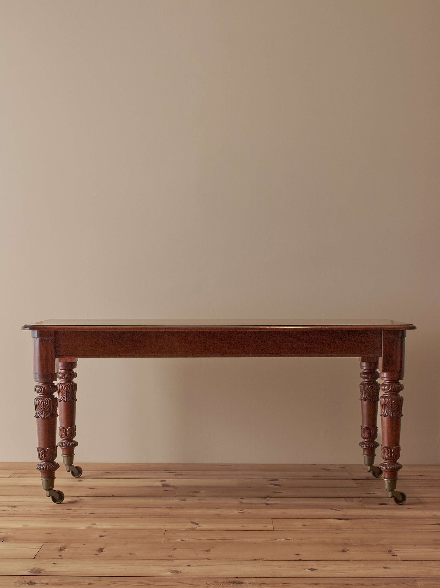 Antique William IV mahogany dining table on brass castors