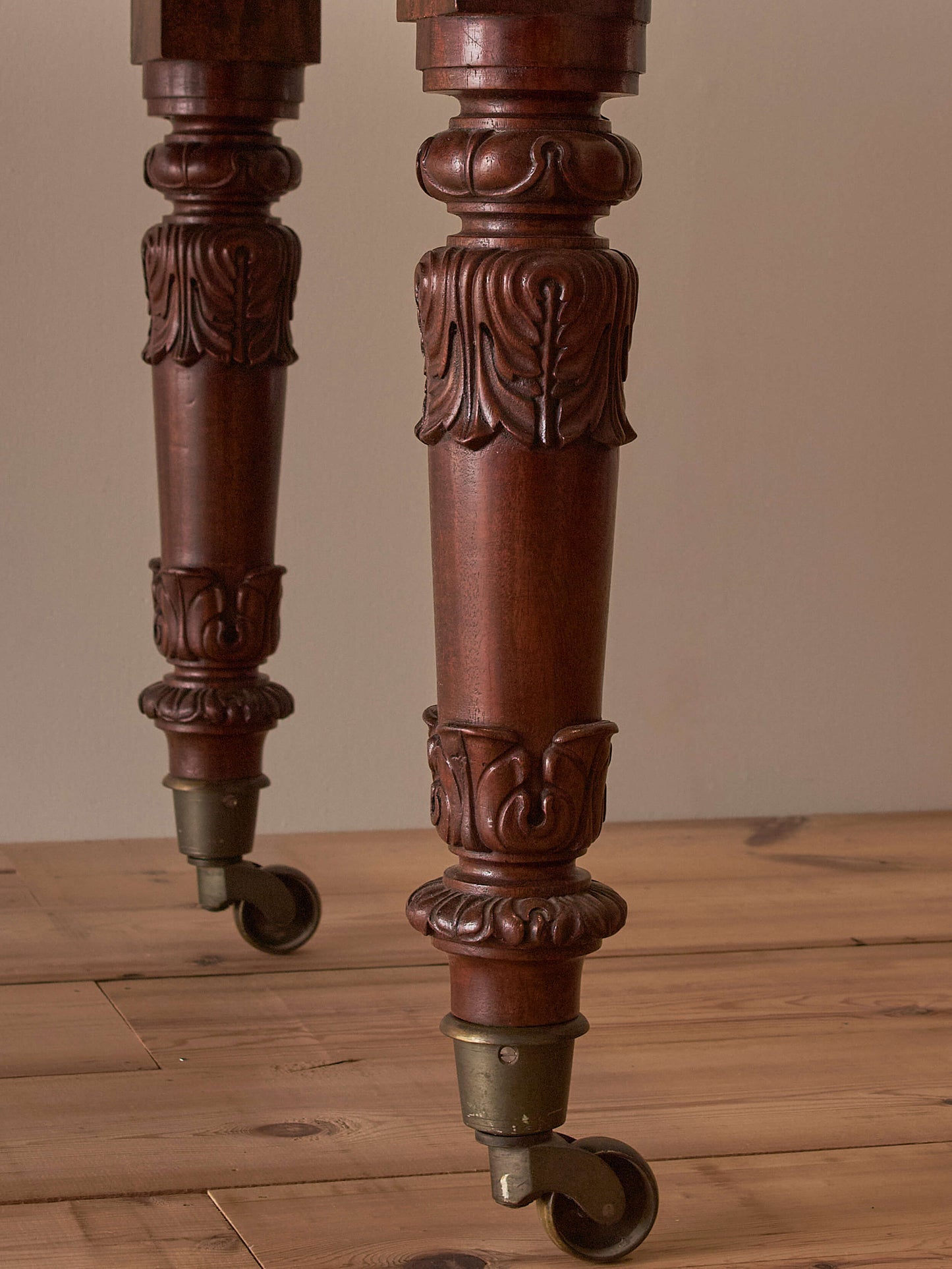 Antique William IV mahogany dining table on brass castors