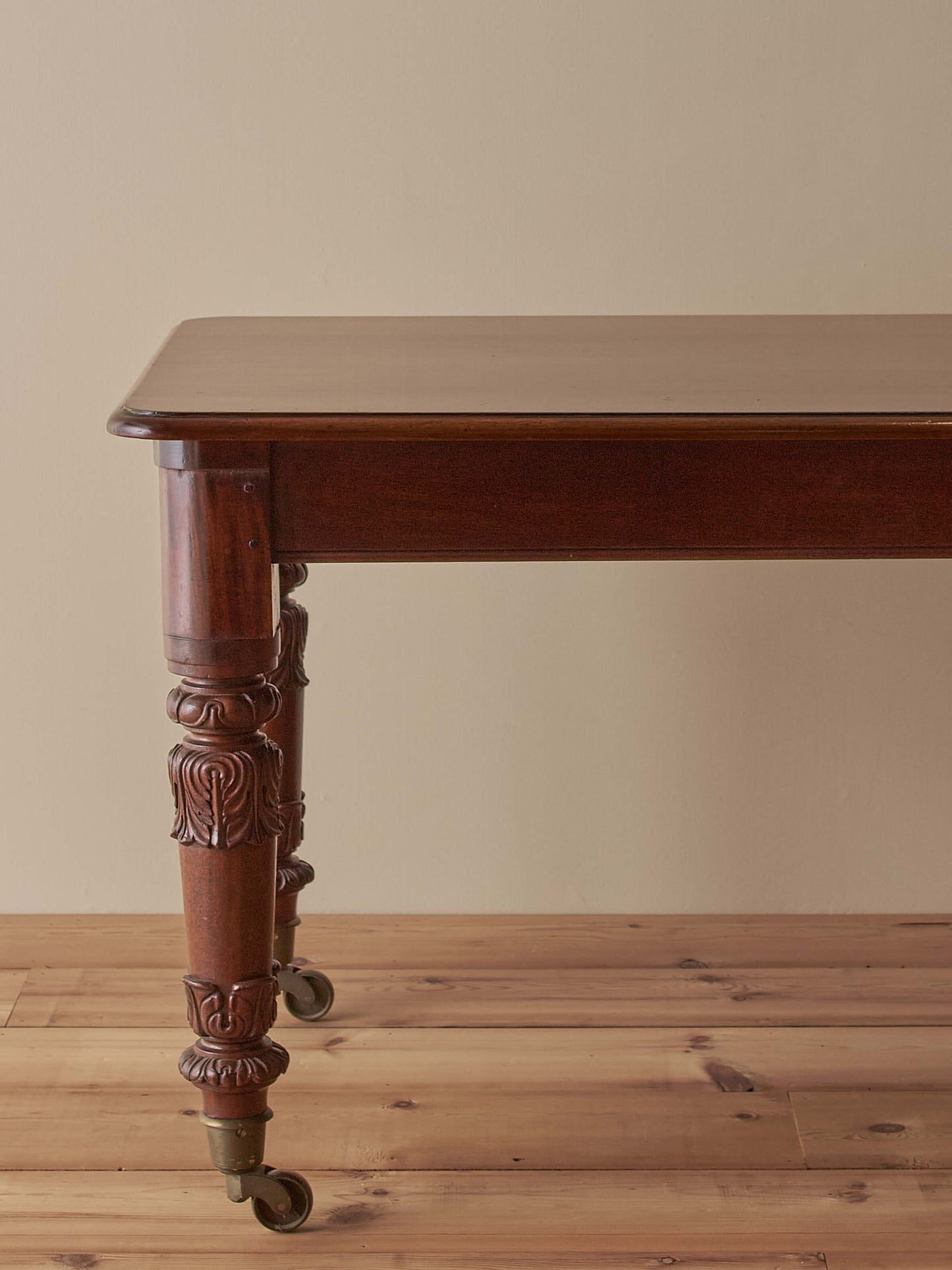Antique William IV mahogany dining table on brass castors