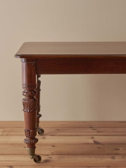Antique William IV mahogany dining table on brass castors