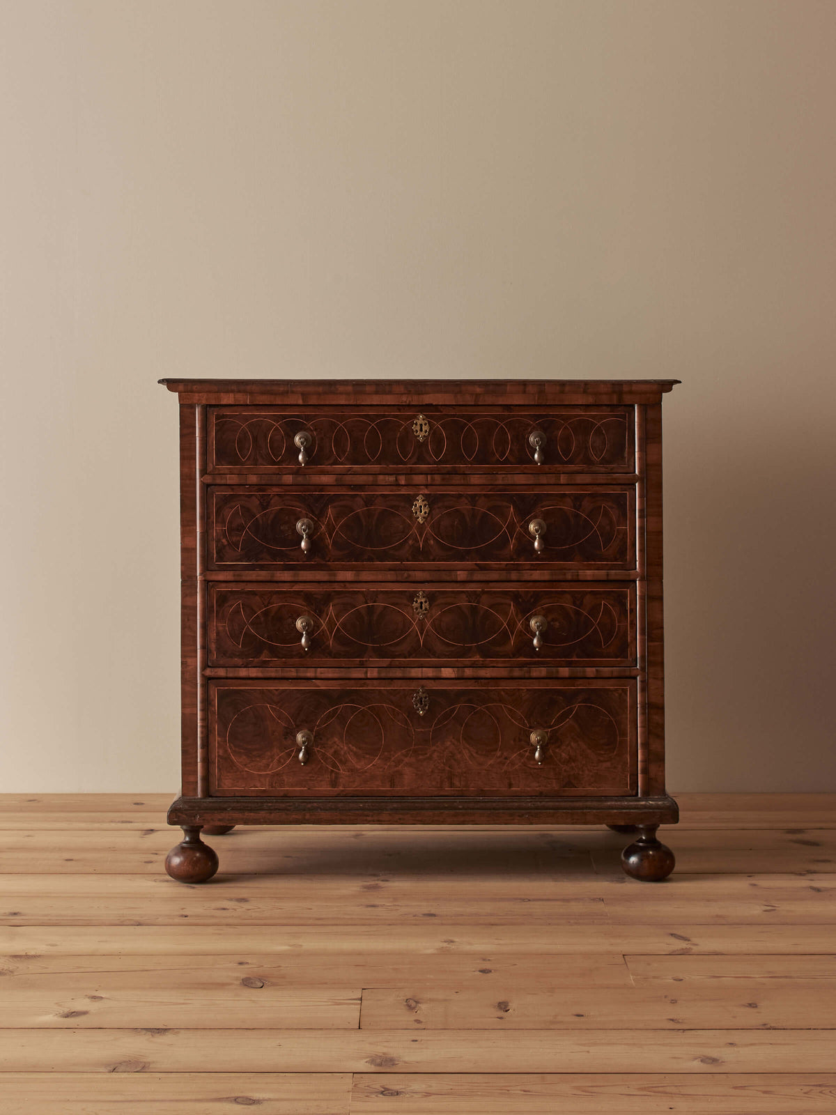 Queen Anne antique olive-oyster chest of drawers on bun feet