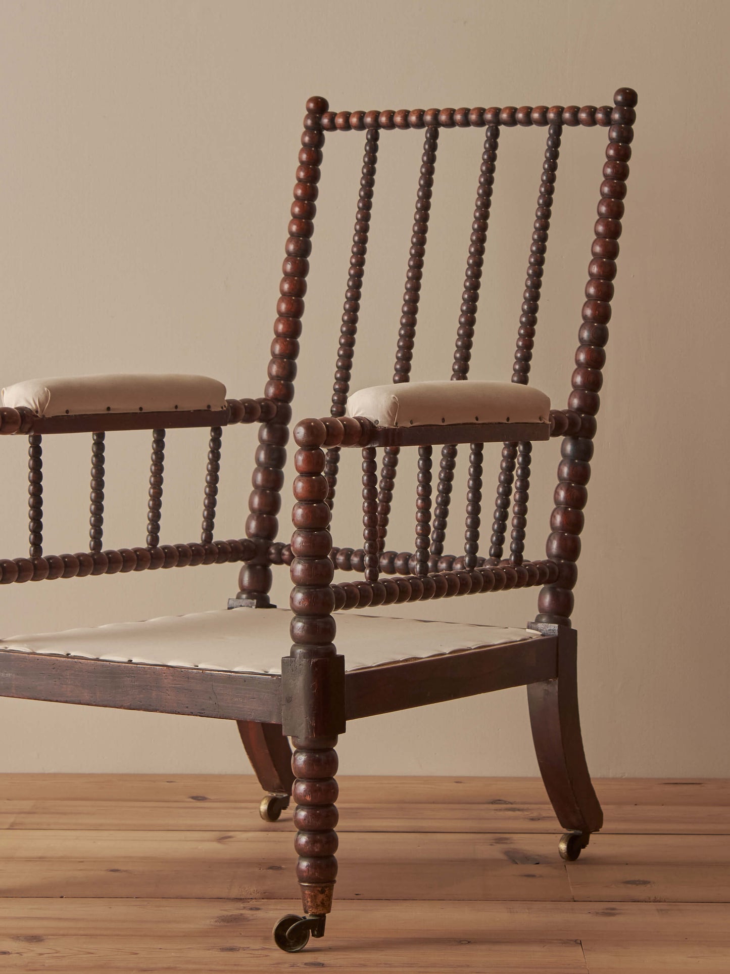 Victorian bobbin armchair raised on castors