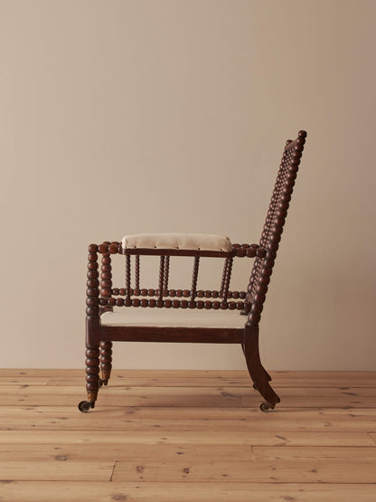 Victorian bobbin armchair raised on castors
