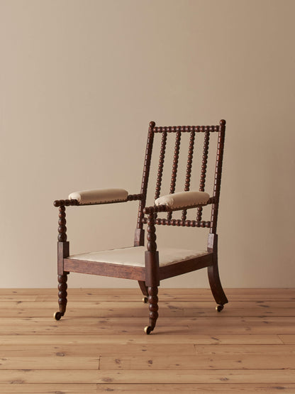 Victorian bobbin armchair raised on castors