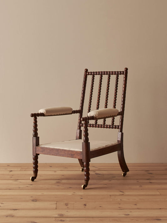 Victorian bobbin armchair raised on castors