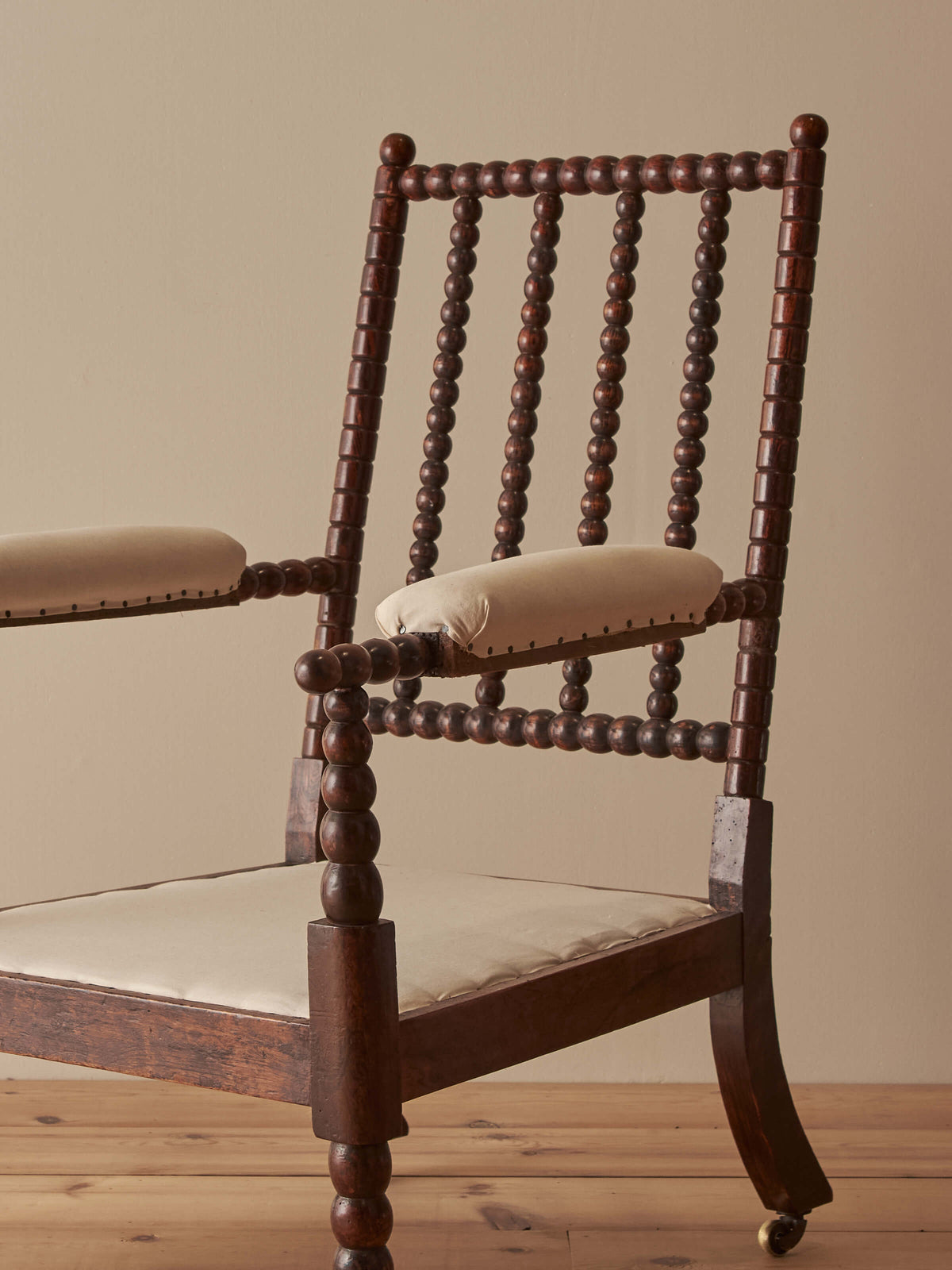 Victorian bobbin armchair raised on castors
