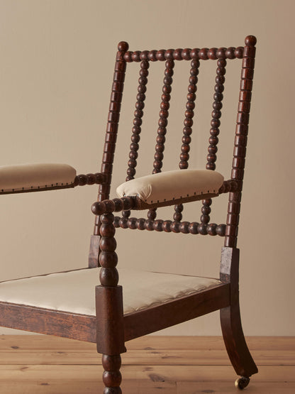 Victorian bobbin armchair raised on castors