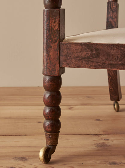 Victorian bobbin armchair raised on castors