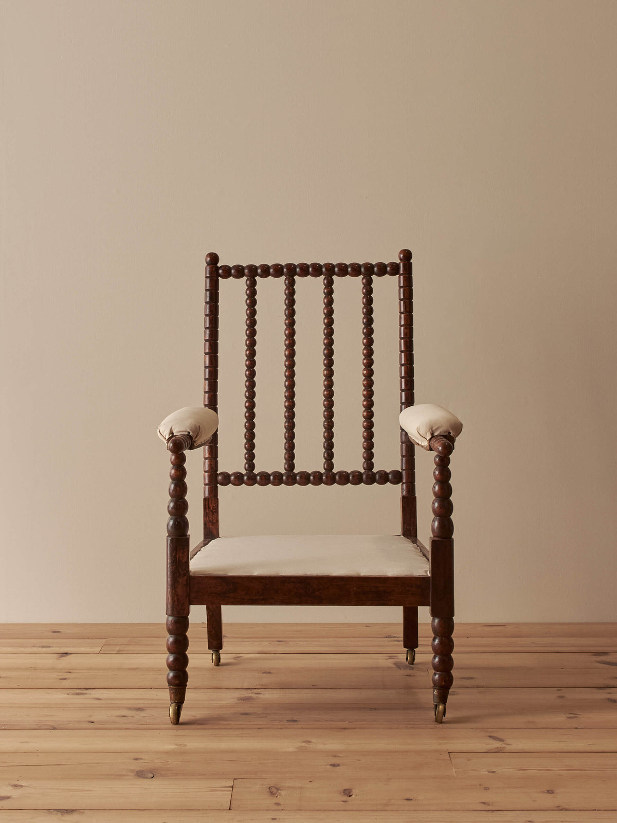 Victorian bobbin armchair raised on castors