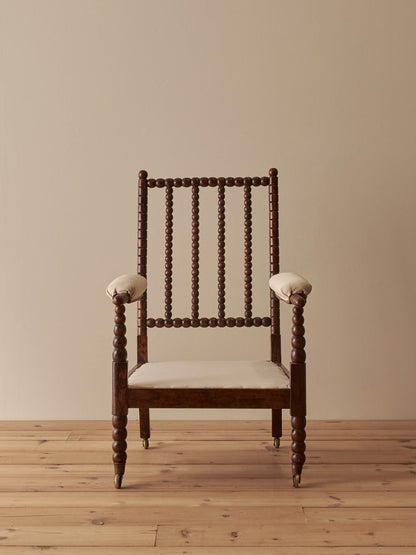 Victorian bobbin armchair raised on castors