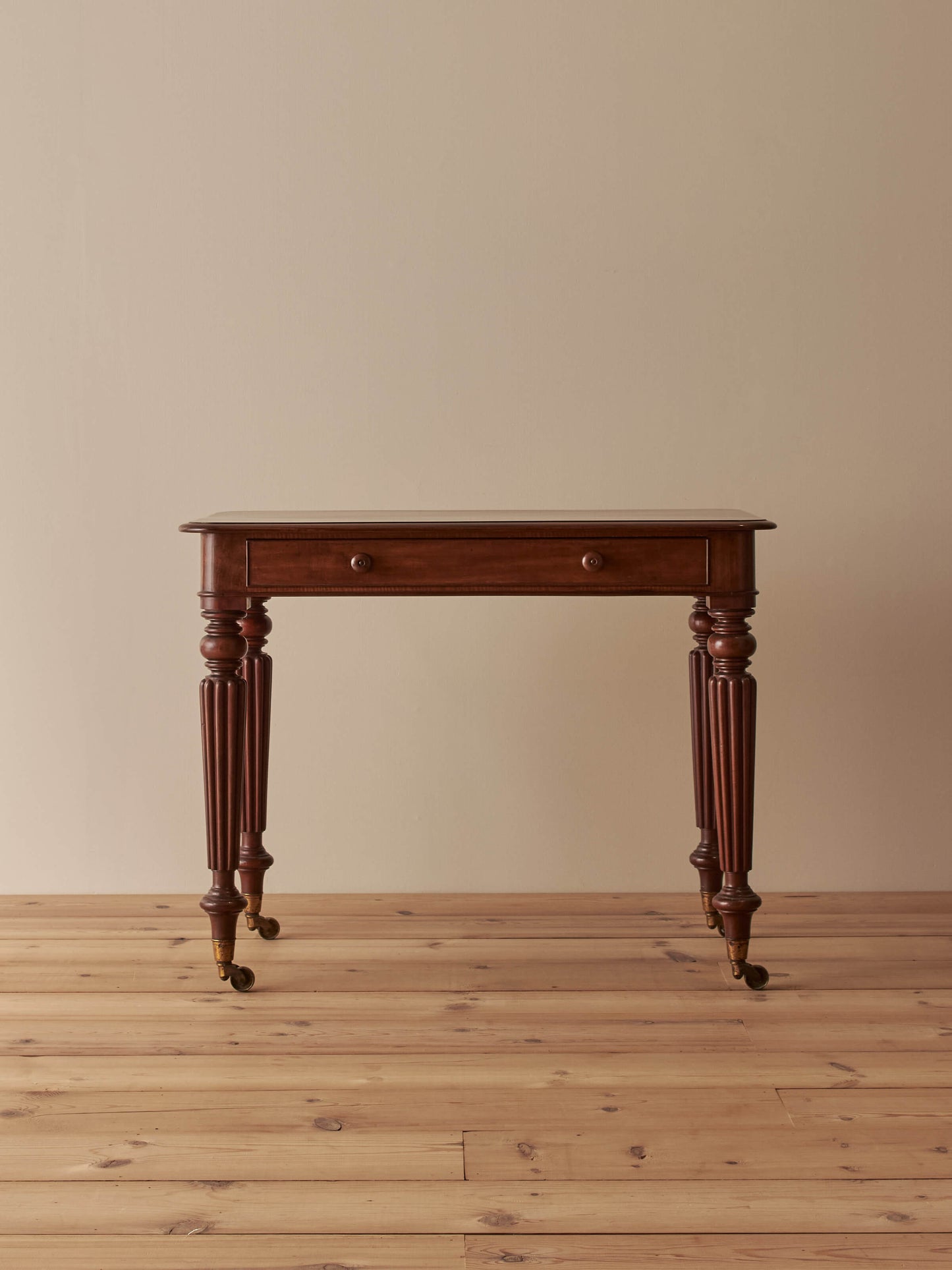 Early Victorian mahogany writing table with fluted legs