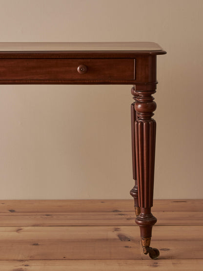 Early Victorian mahogany writing table with fluted legs