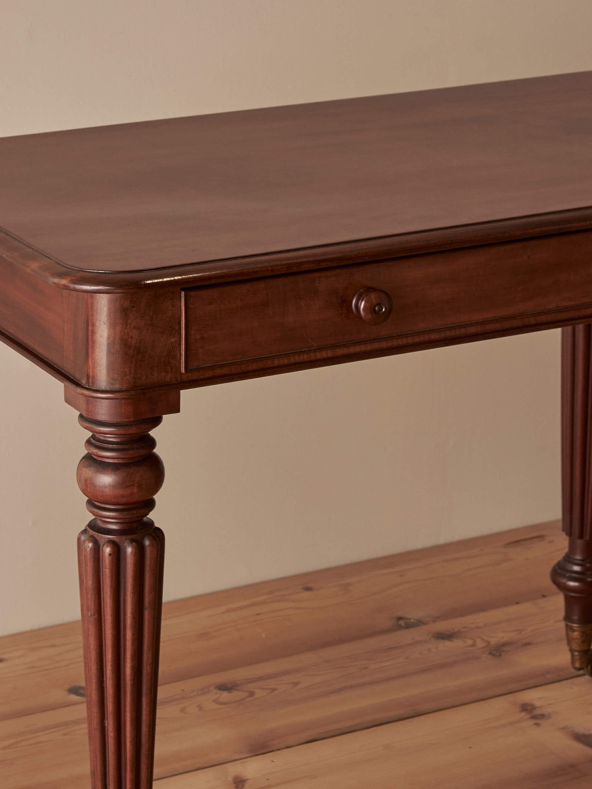 Early Victorian mahogany writing table with fluted legs