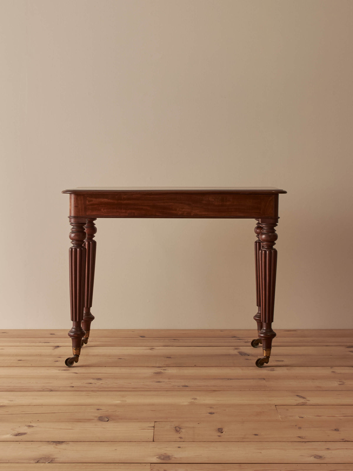 Early Victorian mahogany writing table with fluted legs