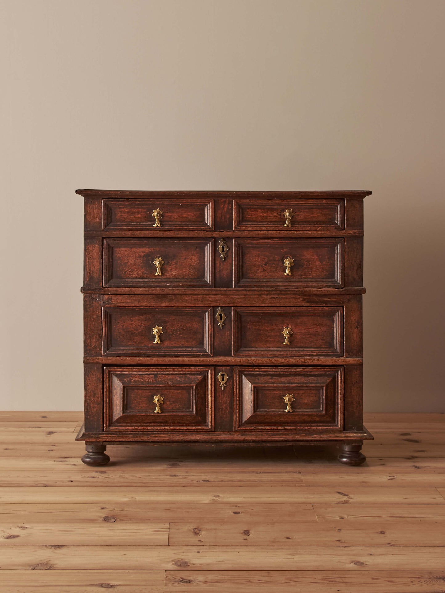 A George I oak chest of drawers on bun feet