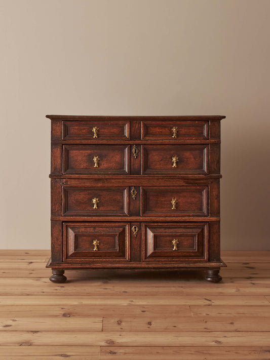 A George I oak chest of drawers on bun feet