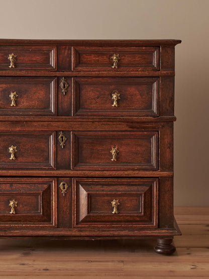 A George I oak chest of drawers on bun feet