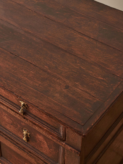 A George I oak chest of drawers on bun feet