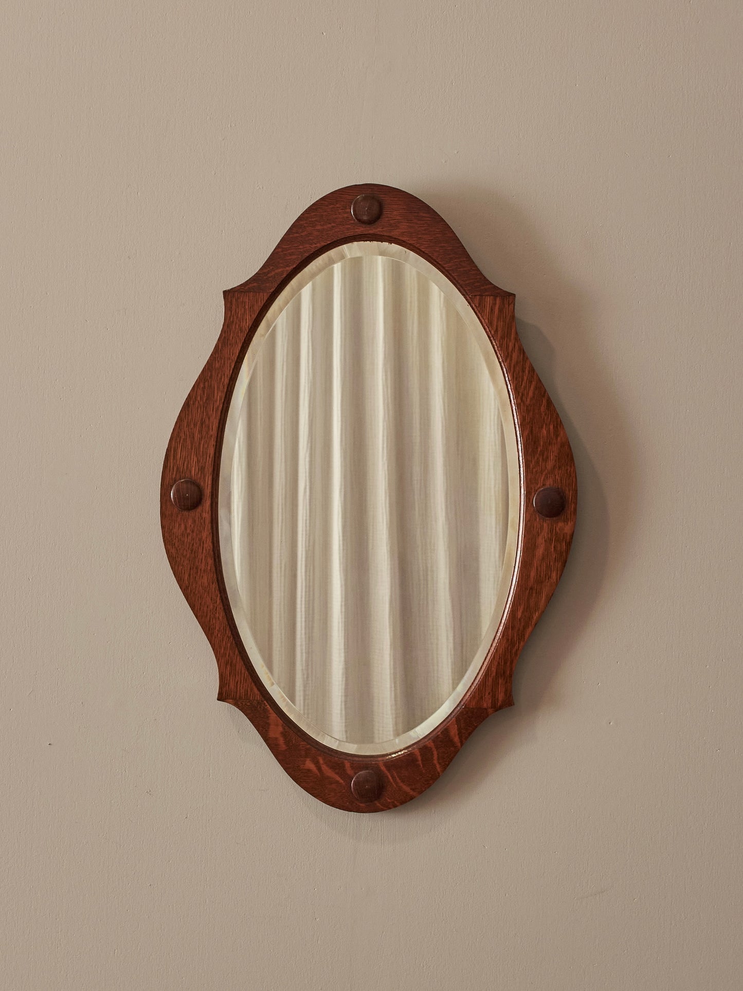 Arts and Crafts oval bevelled mirror