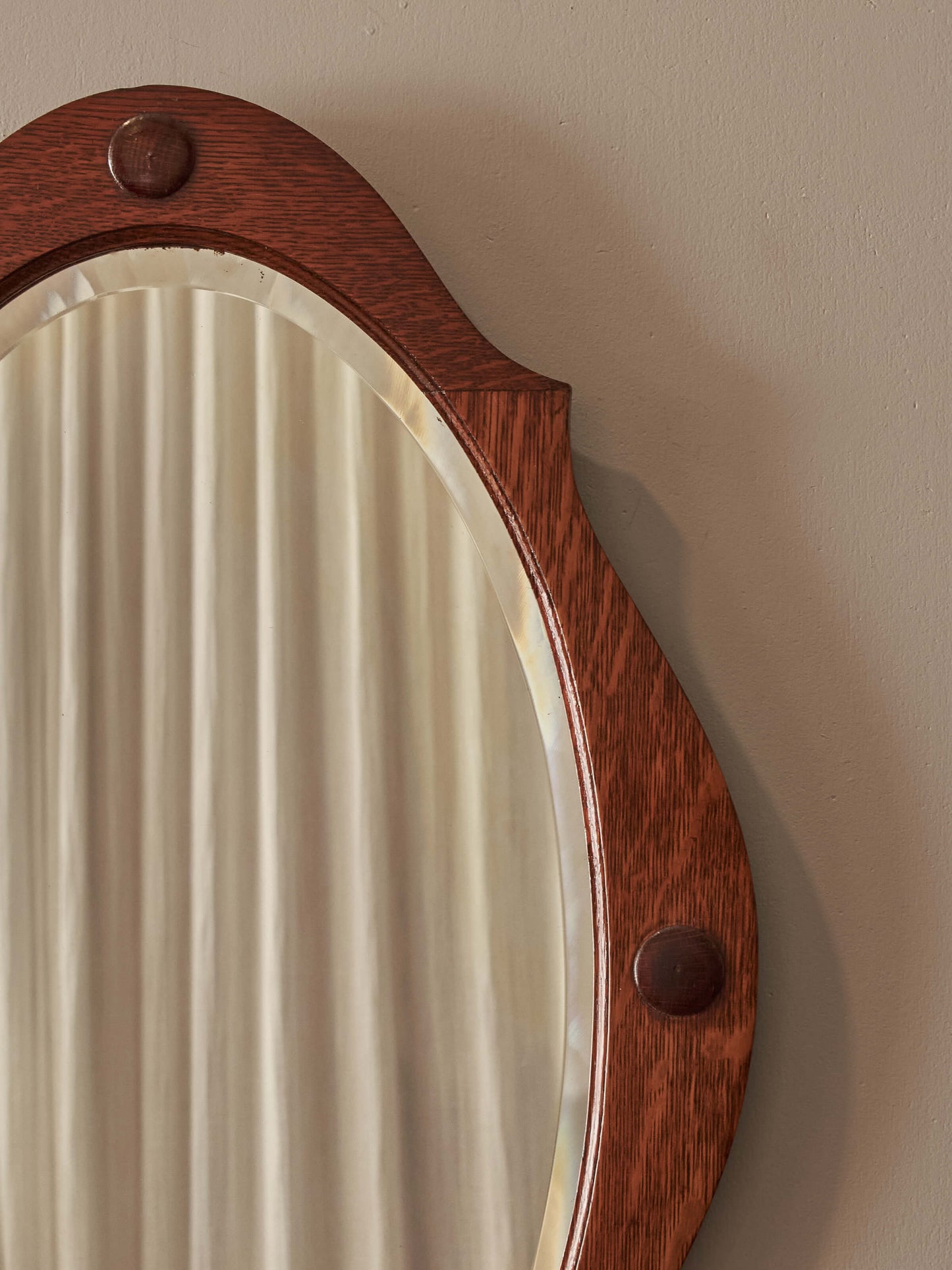 Arts and Crafts oval bevelled mirror