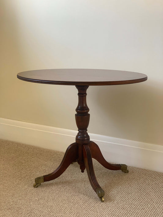 Vintage oval occasional table with brass claw feet