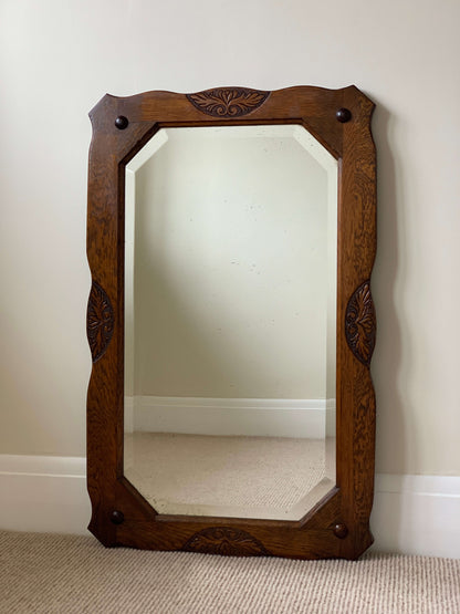 Antique oak-framed bevelled mirror