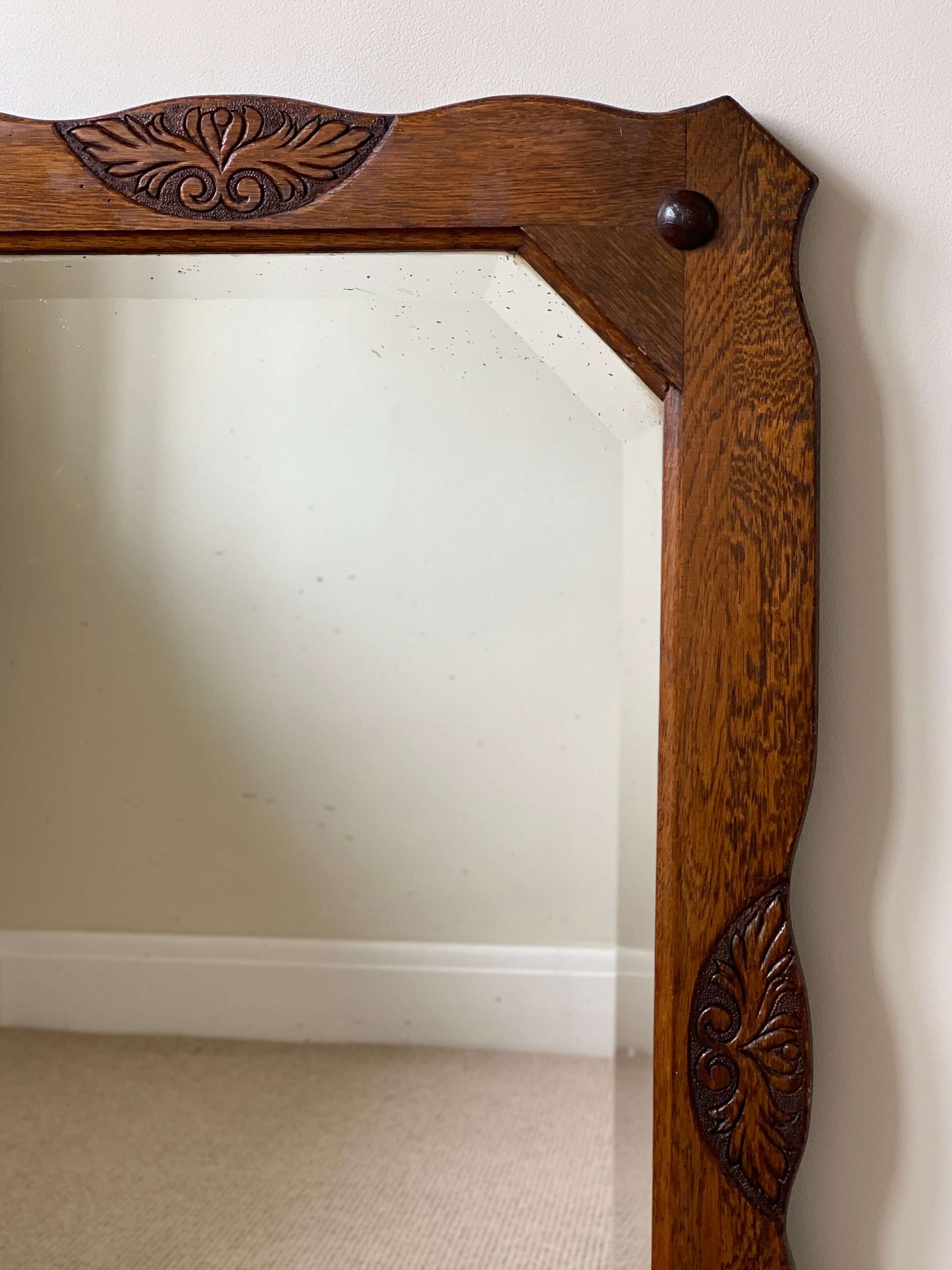 Antique oak-framed bevelled mirror