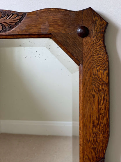 Antique oak-framed bevelled mirror