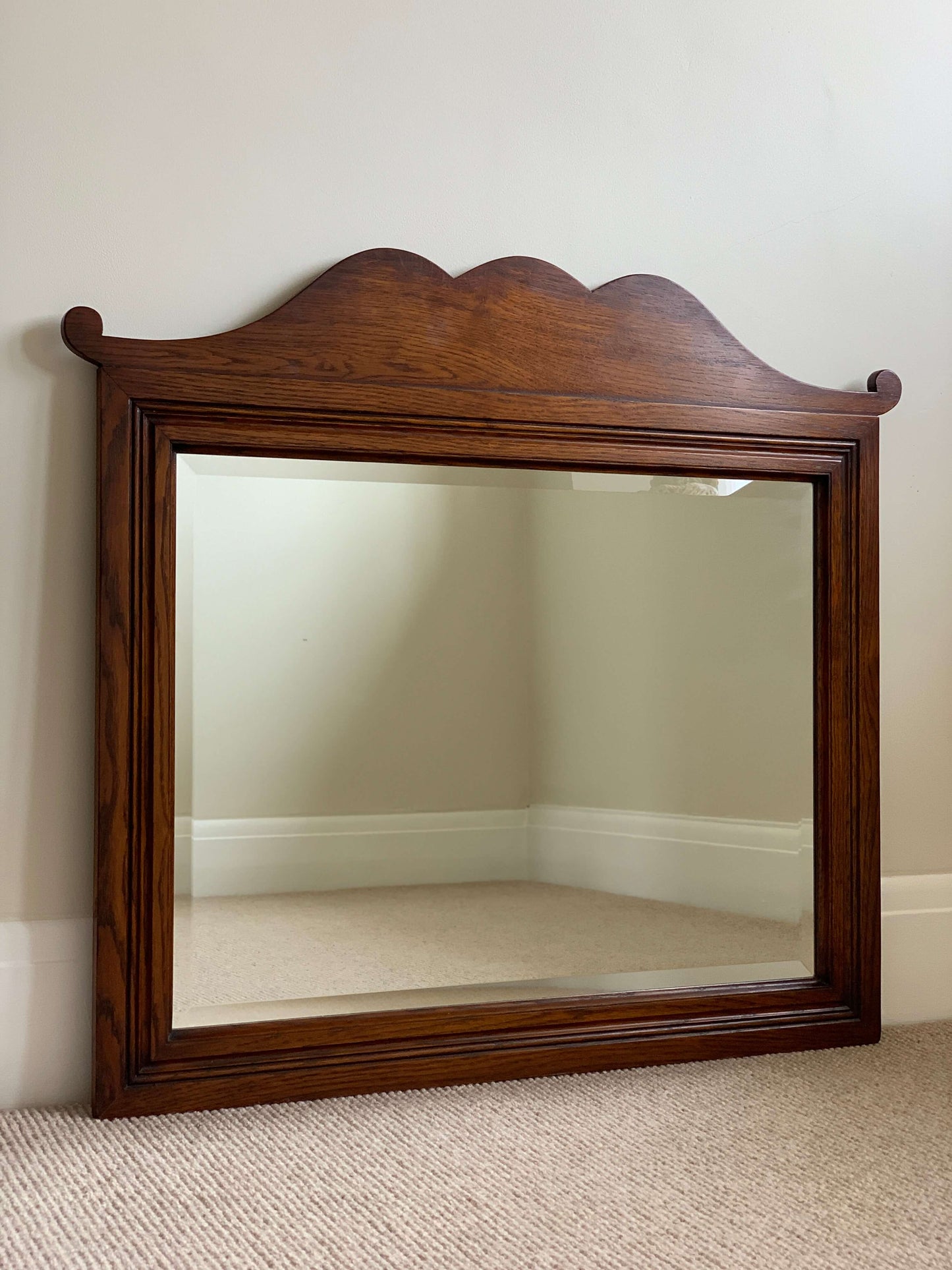 Antique oak framed bevelled mirror with scallop detail